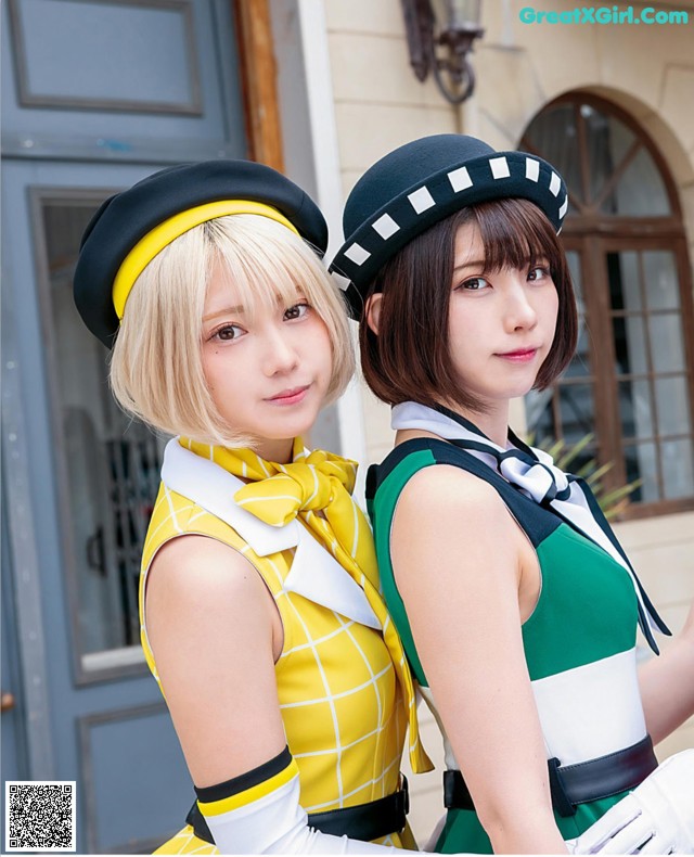 Two young women dressed in uniforms posing for a picture.