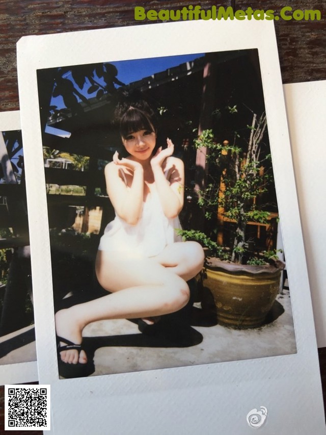 A polaroid photo of a woman posing for a picture.