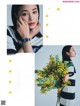 A woman holding a bunch of yellow flowers in a magazine.